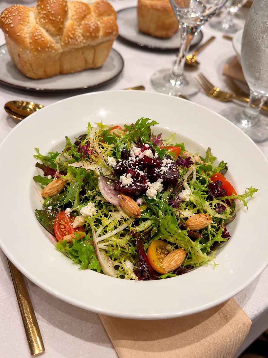 Frisée salad with roasted beets, almonds and cherry tomatoes, set with challah rolls