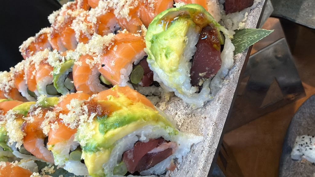 Salmon and avocado sushi rolls with crispy topping